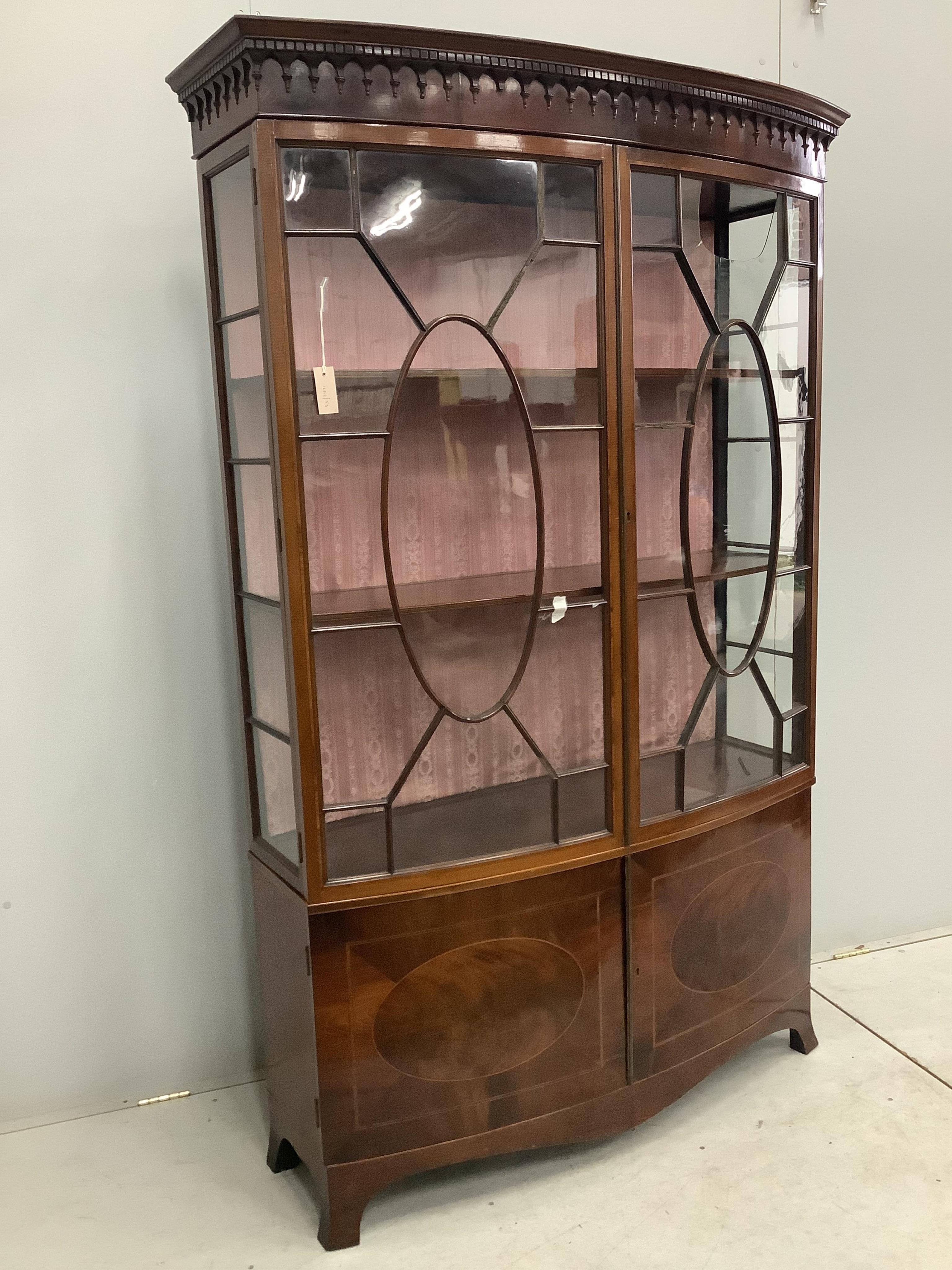 An Edwardian Sheraton style mahogany bow front display cabinet, width 126cm, depth 40cm, height 198cm. Condition - poor, one glass pane damaged